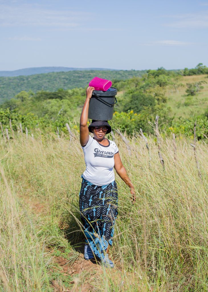 Woman walking through the Eswatini countryside, from UNICEF Eswatini programme storytelling