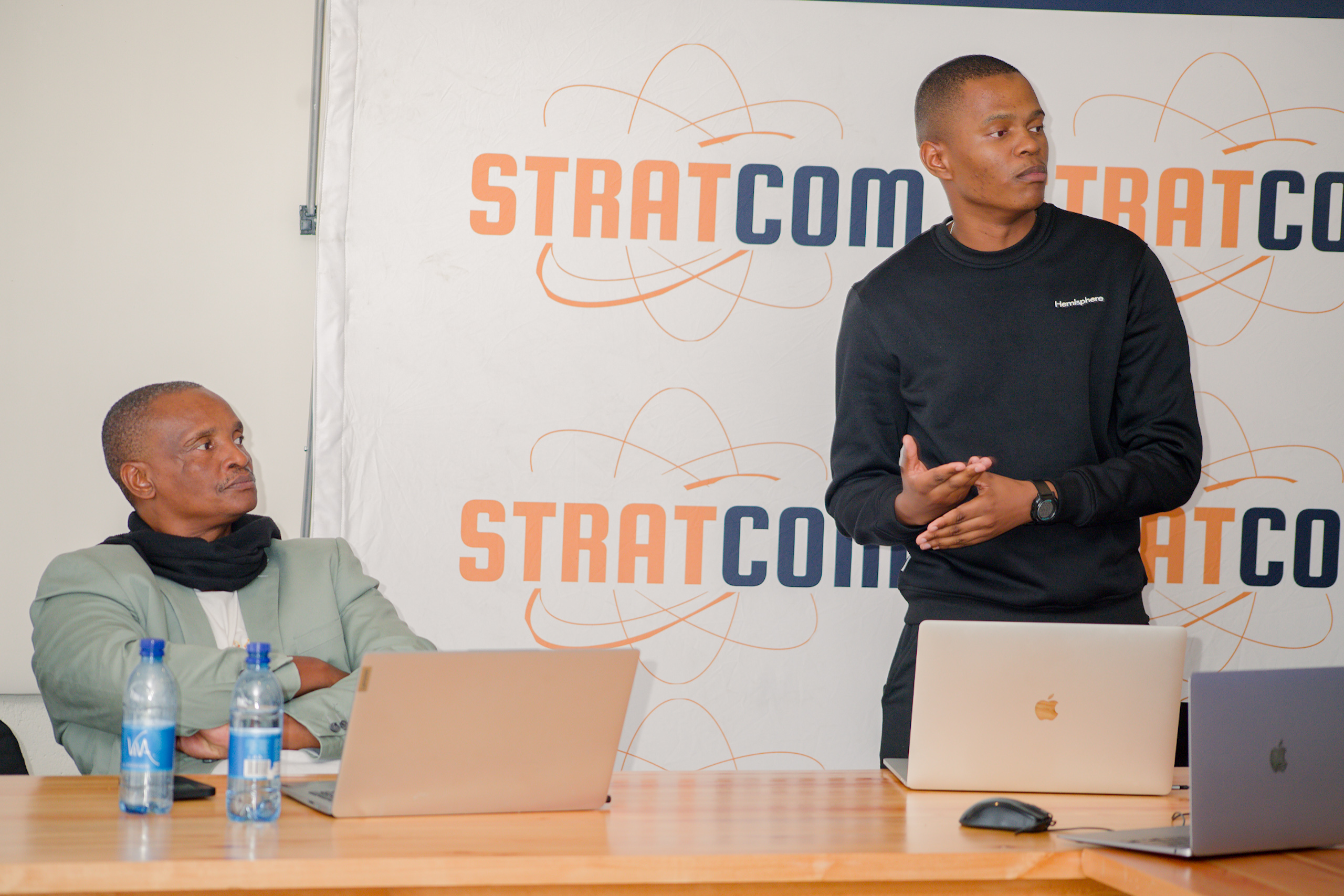 Speaking to the room in front of the Stratcom wall